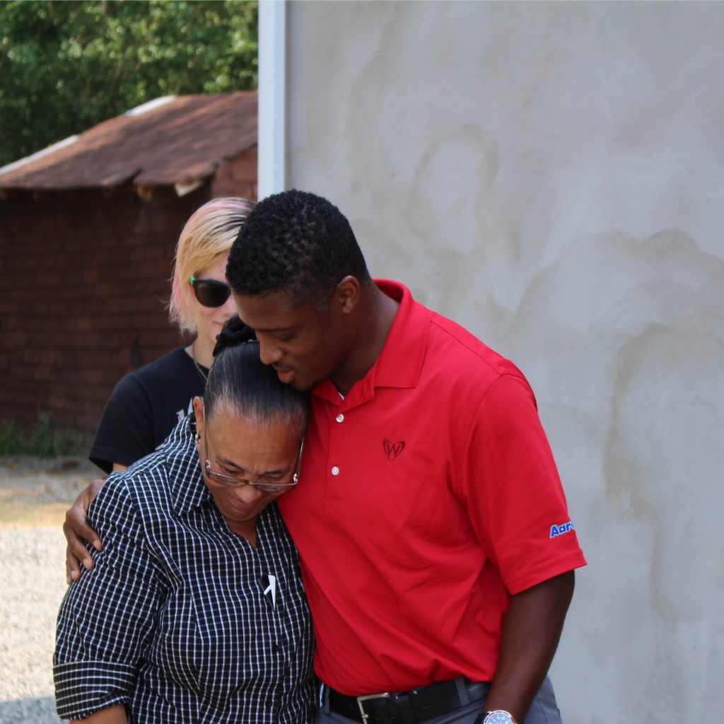 Warrick hugs emotional Homes for the Holiday's recipient