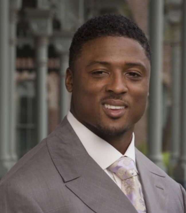 Warrick Dunn headshot in suit